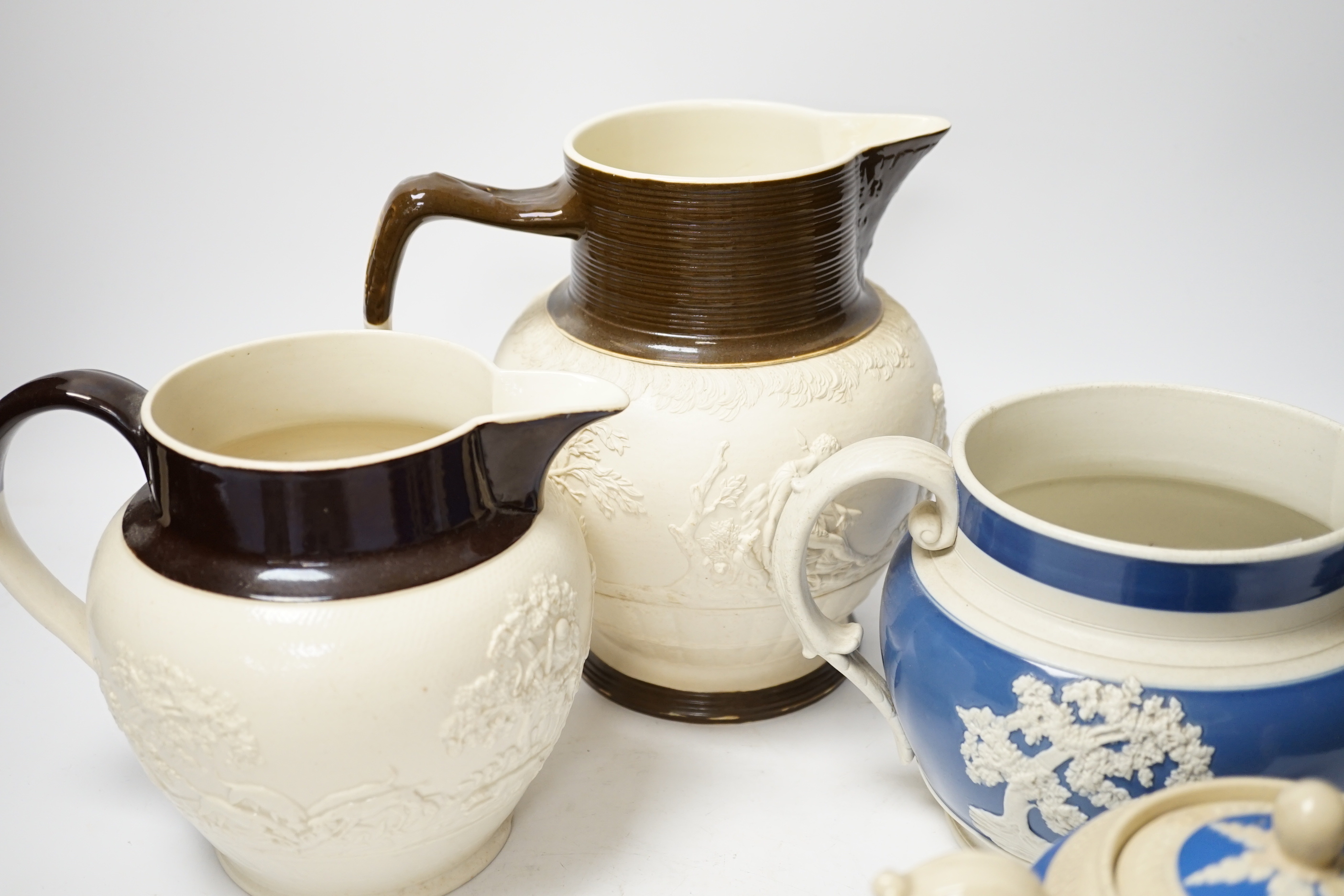 A group of Staffordshire white stonewares: five jugs and a teapot, including Adams, tallest jug 21cm high